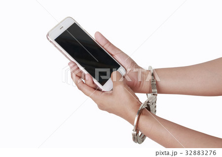 phone in hand with handcuffs phone in hand with handcuffs 32883276