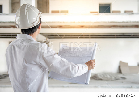 Engineer checking architectural drawing Engineer checking architectural drawing 32883717