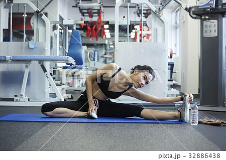 A portrait of a girl doing yoga exercise at a fitness room 32886438