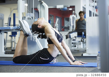 A girl is doing yoga exercise at a room 32886450