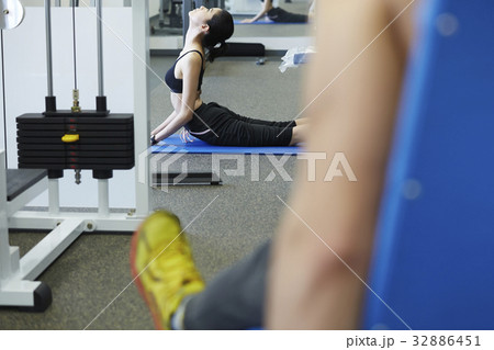 A picture of a girl stretching at a fitness centre 32886451