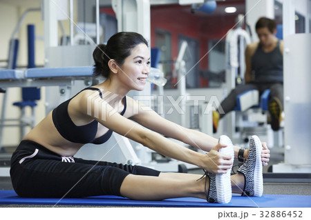 A girl is sitting, practising and smiling at a sport club 32886452