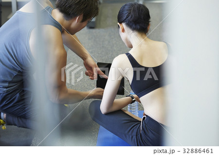 a coach is guiding his trainee at a sport club a coach is guiding his trainee at a sport club 32886461