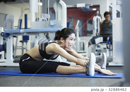 A girl is practising a yoga exercise at a sport club 32886462