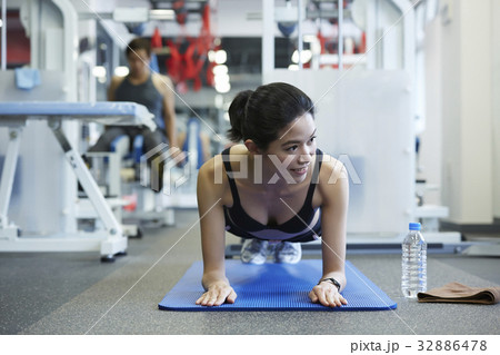 A girl is doing plank and looking at something A girl is doing plank and looking at something 32886478