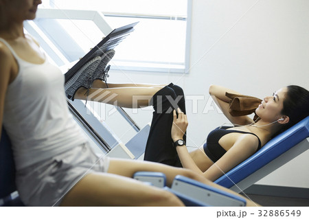 two women are exercising in gym club 32886549
