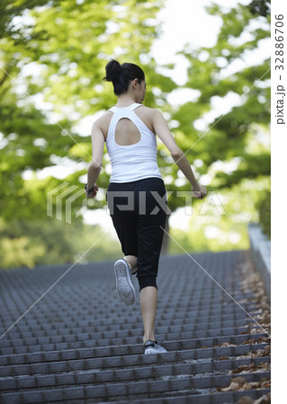 The girl is running up on steps of the stair The girl is running up on steps of the stair 32886706