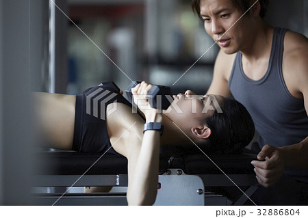 a photo of a man guiding a woman doing gymnastics. 32886804