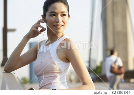 a photo of a woman looking something and smiling. a photo of a woman looking something and smiling. 32886844