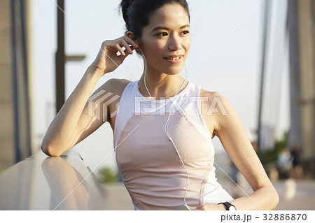 a photo of a woman listening to music and smiling a photo of a woman listening to music and smiling 32886870