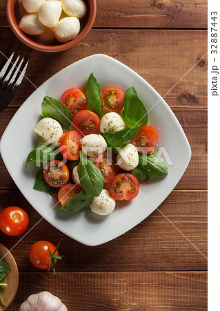 caprese salad in plate at wood 32887443