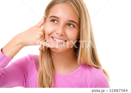 Portrait of young girl taking a call me gesture 32887564