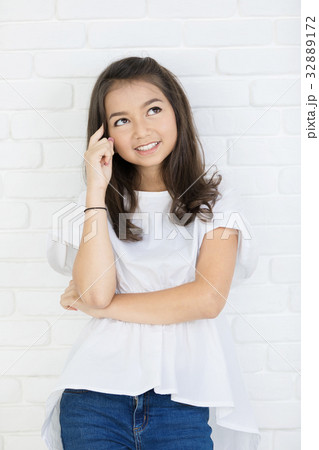 Portrait of happy cute girl thinking. 32889172