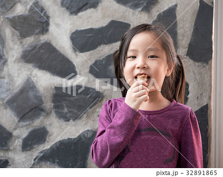Little Asian girl eating ice cream 32891865