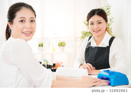woman doing manicure and her manicurist 32892661