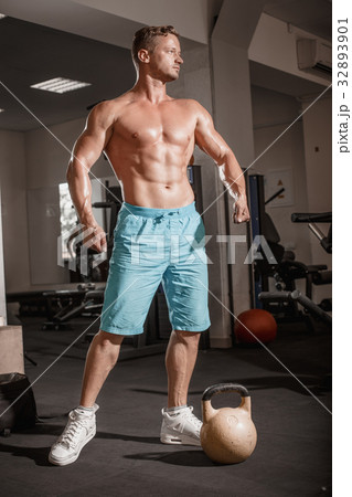 Muscular bodybuilder guy doing exercises with Muscular bodybuilder guy doing exercises with 32893901