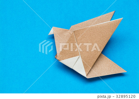 Brown origami paper in flying bird shape 32895120