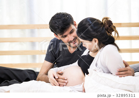 man touching pregnant woman with happy emotion 32895311