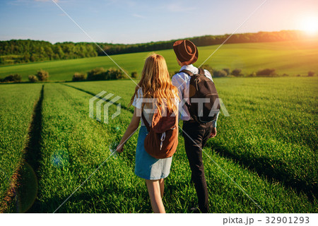 With a backpack, a man in a hat and a woman  32901293
