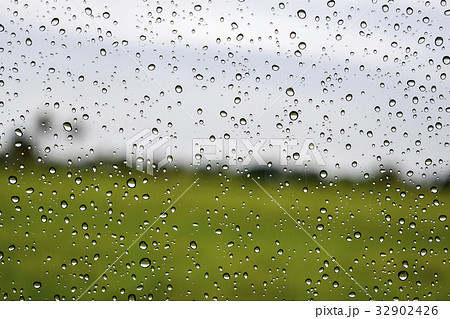 Rain drop on the car glass green background Rain drop on the car glass green background 32902426