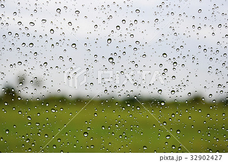 Rain drop on the car glass, blur background Rain drop on the car glass, blur background 32902427