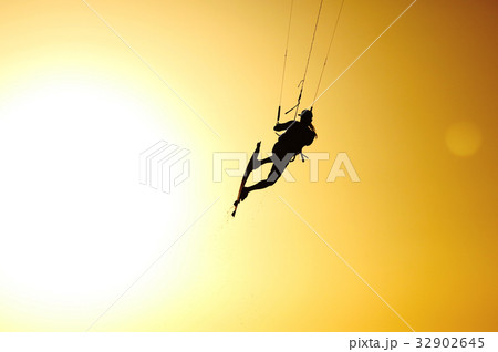 Kiteboarding sportsman silhouette on sunset sky 32902645