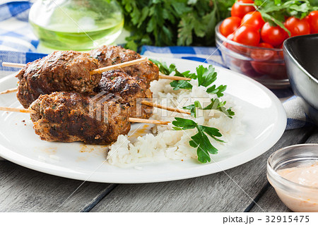 Barbecued kofta with rice on a plate 32915475