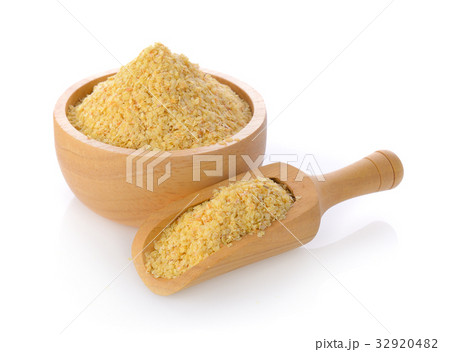 Wheat germ in a bowl and scoop on white background 32920482