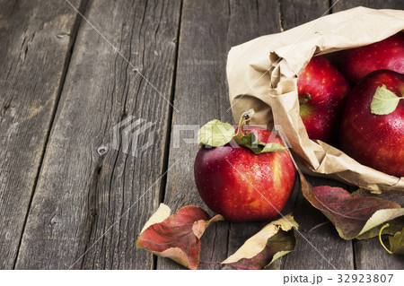 Apples in paper package on dark wooden background Apples in paper package on dark wooden background 32923807
