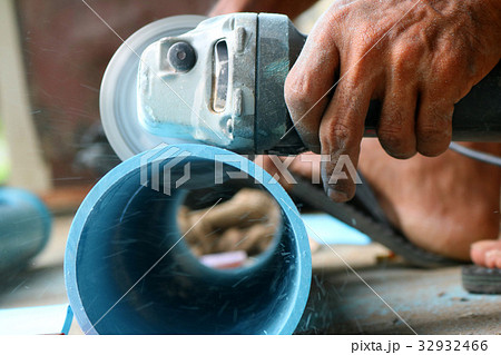 Electric circular saw cutting the PVC pipe Electric circular saw cutting the PVC pipe 32932466