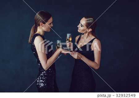 Attractive women in cocktail dresses are holding Attractive women in cocktail dresses are holding 32932549