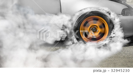 Drag racing car burns off its tires for the race 32945230