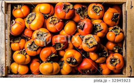Box of fresh fruits persimmon kaki on wooden Box of fresh fruits persimmon kaki on wooden 32945923