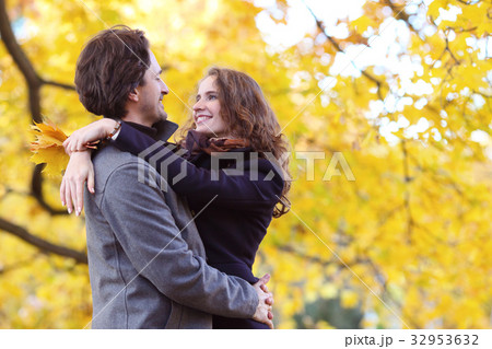 Smiling couple hugging in autumn park Smiling couple hugging in autumn park 32953632
