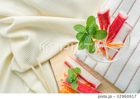 Crab stick with sliced carrot and radish in glass Crab stick with sliced carrot and radish in glass 32960917