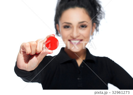 Attractive brunette holding casino tokens 32961273