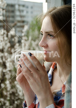 Young woman with a cup of tea on the balcony 32961294