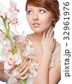 beautiful girl with big orchid on white 32961976