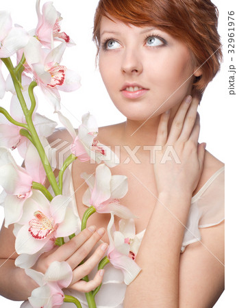 beautiful girl with big orchid on white 32961976