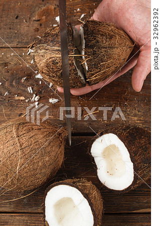 Coconuts cut on brown wooden background Coconuts cut on brown wooden background 32962392