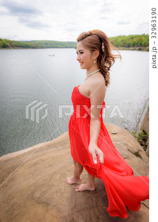 woman wear red evening dress enjoying mountain. 32963190