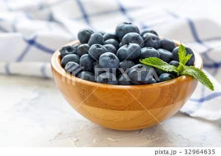 Fresh blueberries in a wooden bowl. Fresh blueberries in a wooden bowl. 32964635