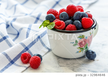 Mug with fresh berries. Mug with fresh berries. 32964646