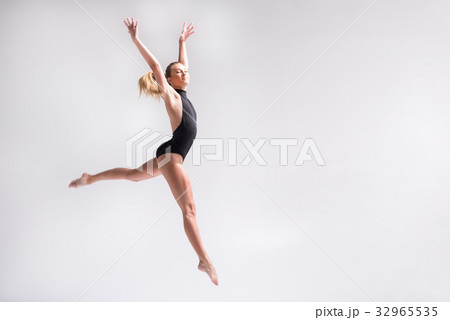 Sublime youthful lady performing gymnastics 32965535