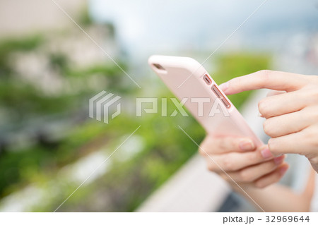 Woman use of cellphone at outdoor Woman use of cellphone at outdoor 32969644