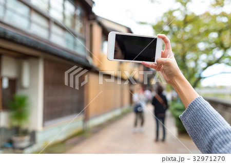 Woman taking photo with cellphone in kanazawa Woman taking photo with cellphone in kanazawa 32971270