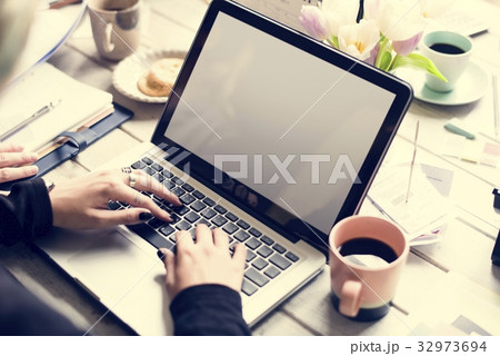 Woman using laptop with flower decorated Woman using laptop with flower decorated 32973694
