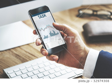 Hands working on digital device network graphic overlay 32974308