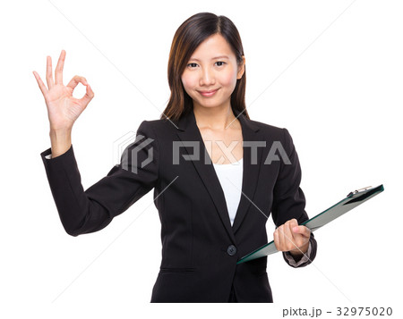 Business woman with clipboard and ok sign 32975020