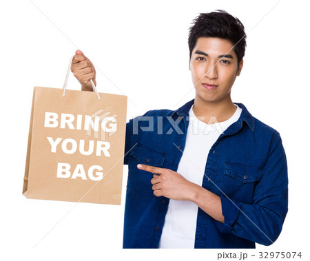 Asian mixed Indian man finger point to shopping bag for showing phrase of bring your bag 32975074